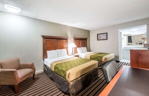 Two single beds with matching headboards, a desk area, and comfortable seating.