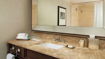 A bathroom with a double sink vanity, a large mirror, and a towel rack.