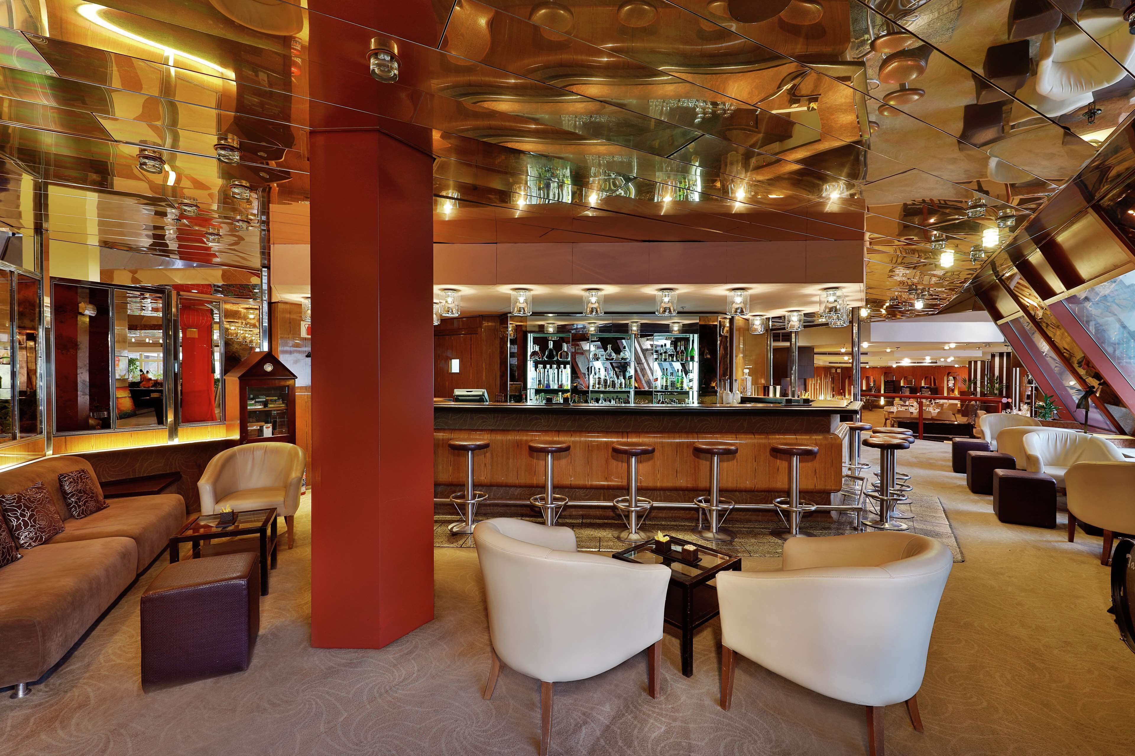 A modern bar area with seating and a bar counter.