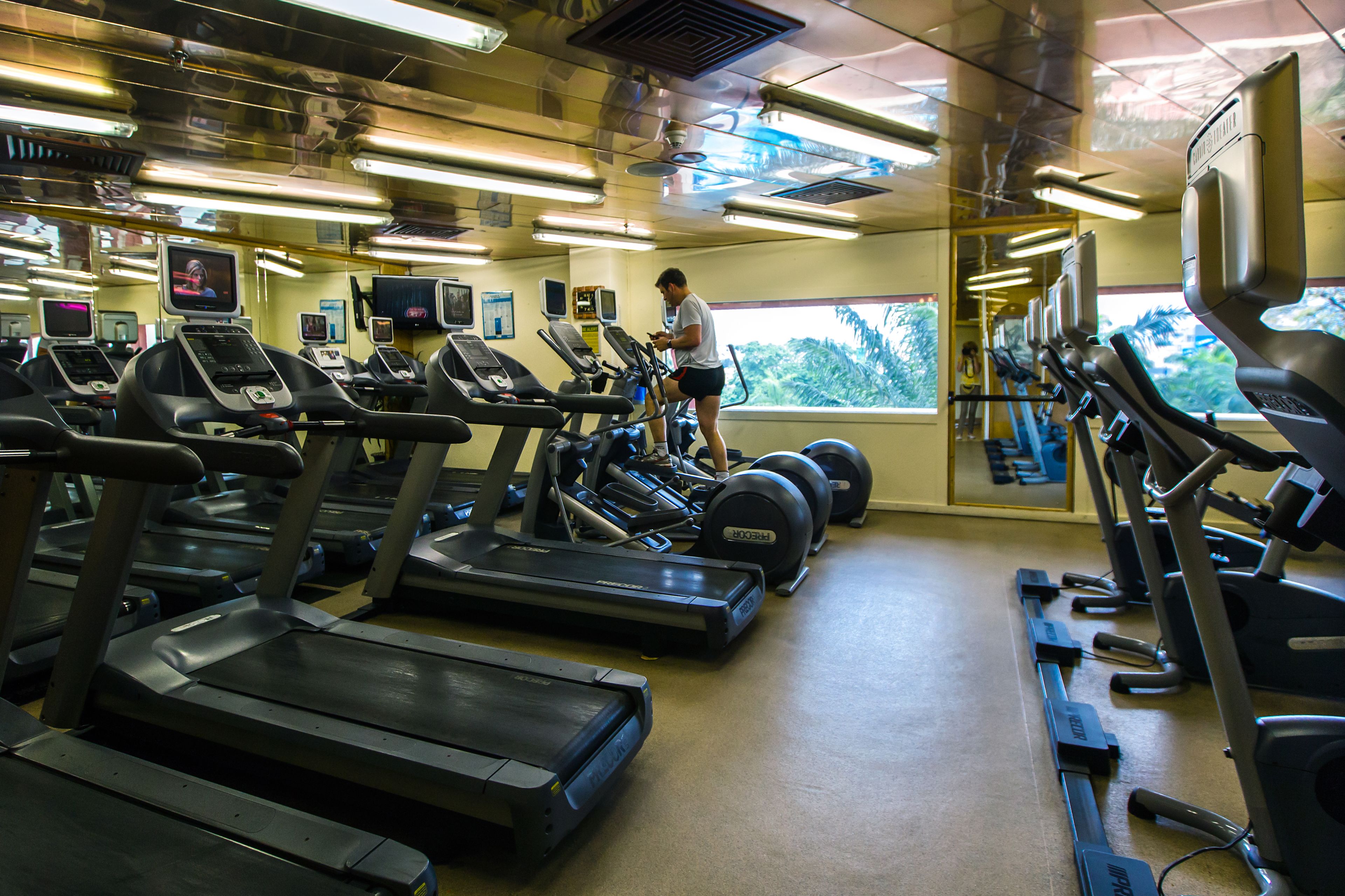 A gym with multiple treadmills and exercise equipment.