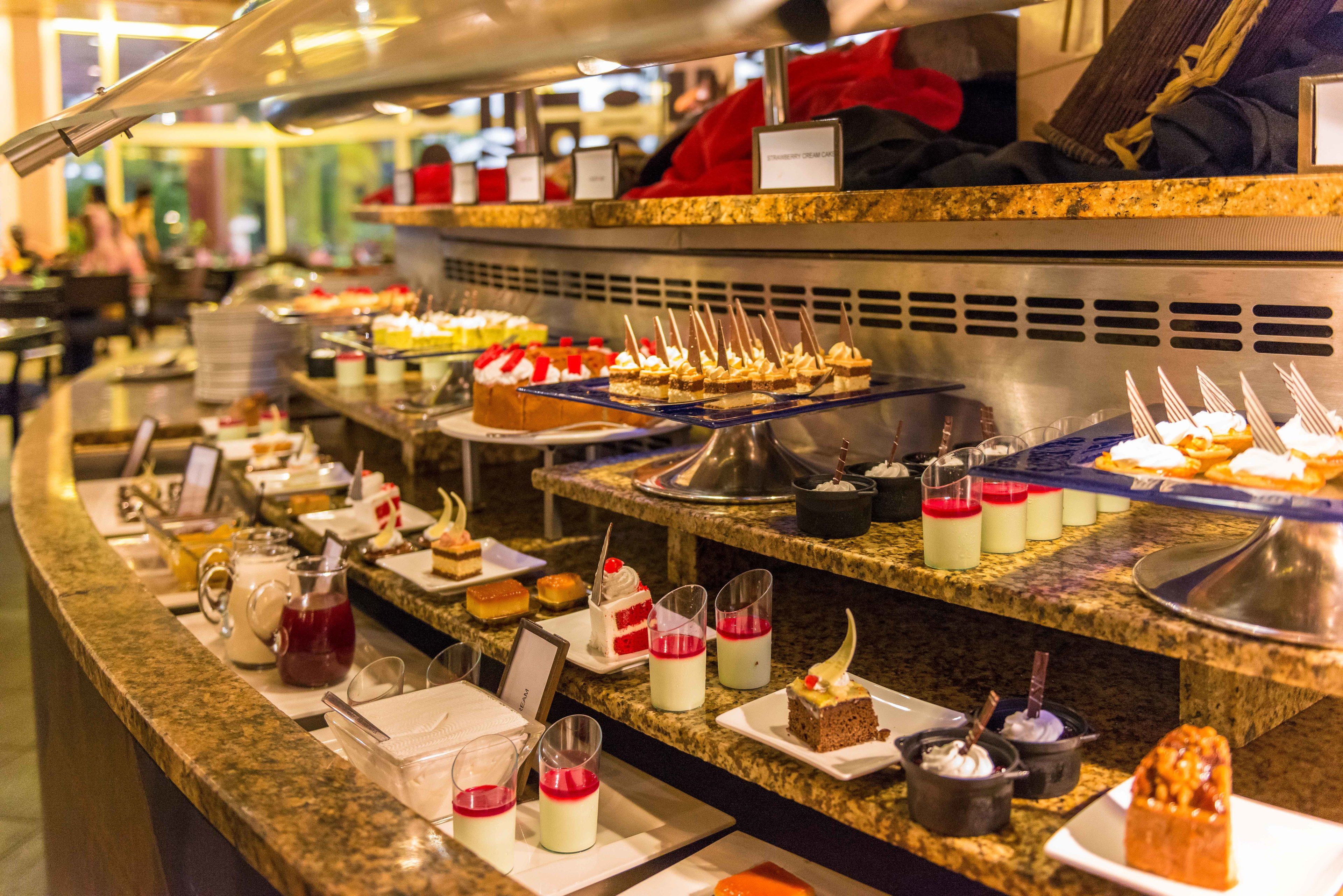 A buffet with various desserts and beverages.