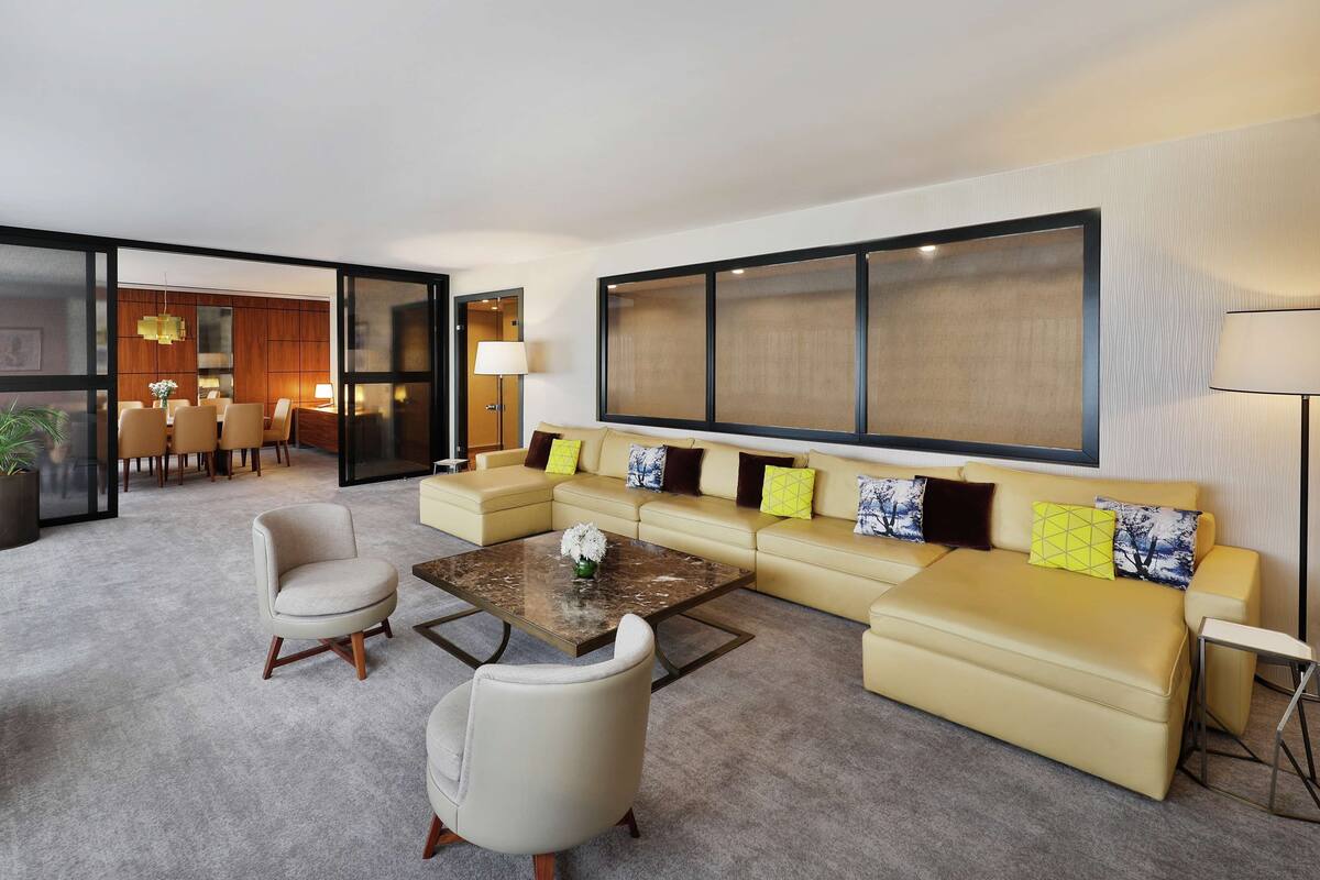 A modern living room with a sofa set, a coffee table, and a TV.