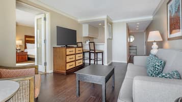 A modern living room with a sofa, a coffee table, a TV, and a wooden cabinet.