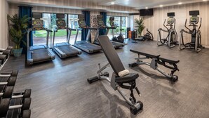A gym with treadmills, elliptical machines, and weight benches. - Crowne Plaza Phoenix - Chandler Golf Resort by IHG (Chandler)