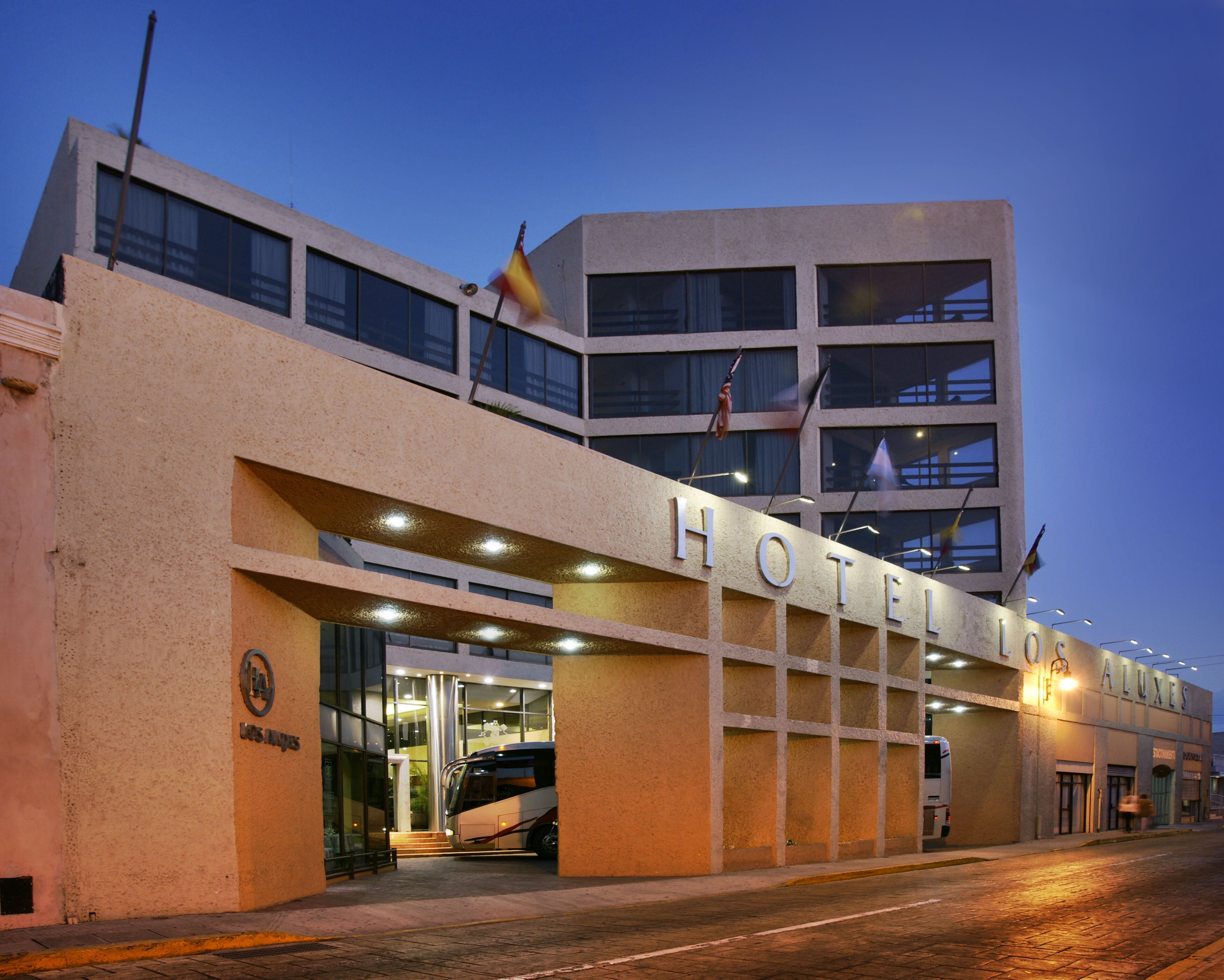 A hotel with a modern facade, multiple windows, and a visible entrance.