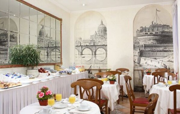 A dining area with tables set for breakfast, featuring a buffet with various food items and a large window with a view of a bridge. - Hotel Genio (Rome)