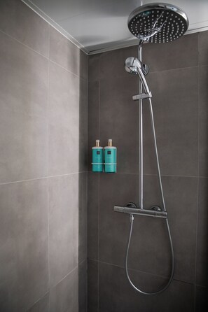 Bathtub, eco-friendly toiletries, hair dryer, towels