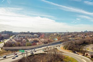 A highway with multiple lanes and vehicles, surrounded by residential buildings and trees. - Sheraton Pentagon City Hotel (Arlington)