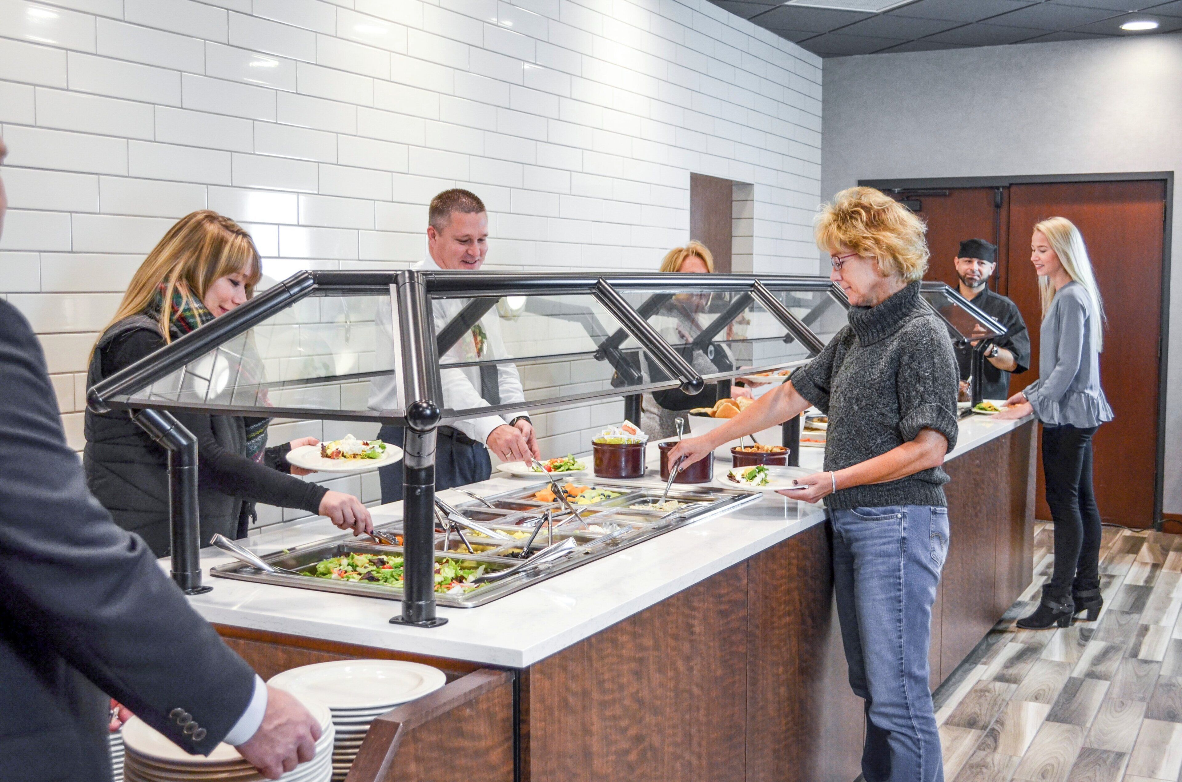 A buffet area with multiple serving stations and a variety of food options.