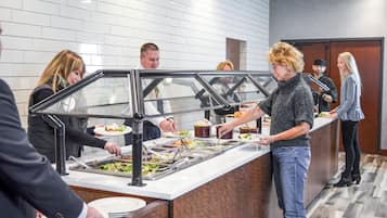 A buffet area with multiple serving stations and a variety of food options.