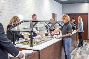 A buffet area with multiple serving stations and a variety of food options.