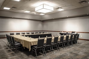 A conference room with a long table, chairs, and a buffet table. - Holiday Inn Fargo by IHG (Fargo)