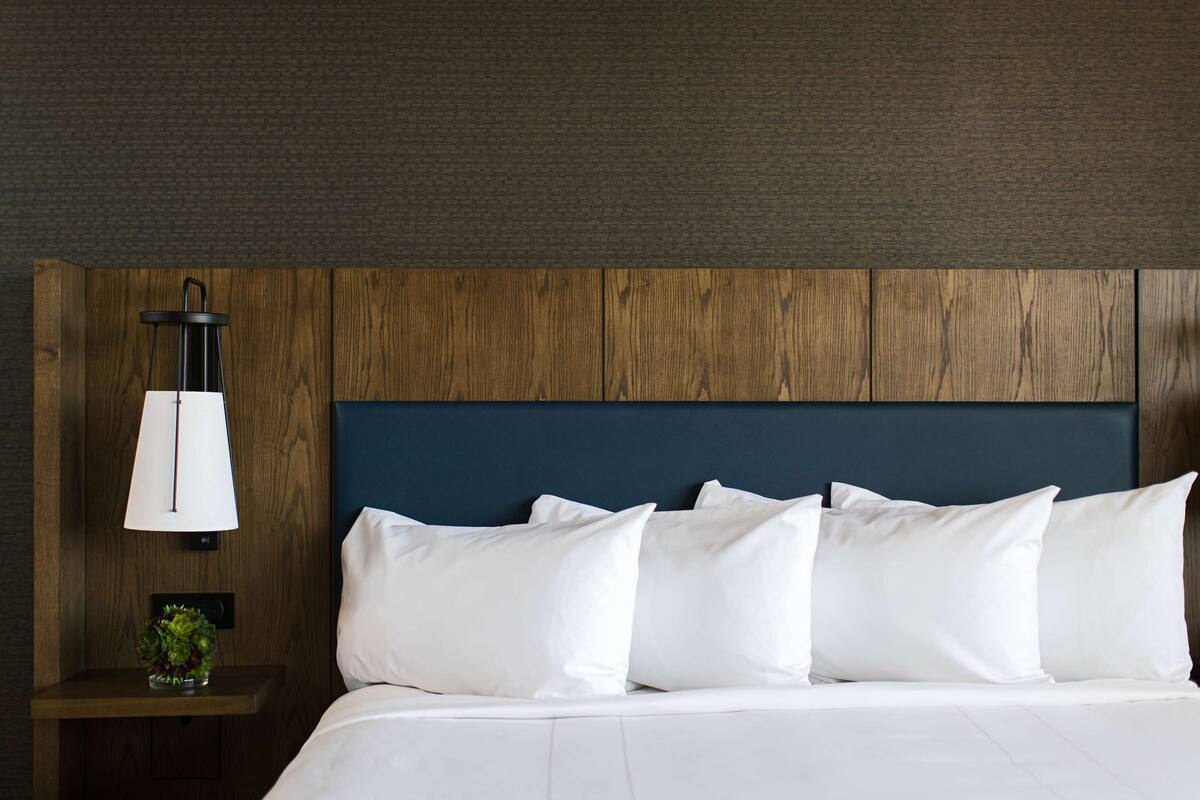 pillow-top beds, desk, laptop workspace, blackout curtains