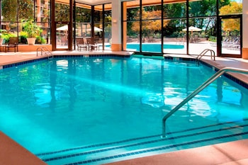 Indoor pool, seasonal outdoor pool, pool umbrellas, sun loungers at Sonesta Nashville Airport