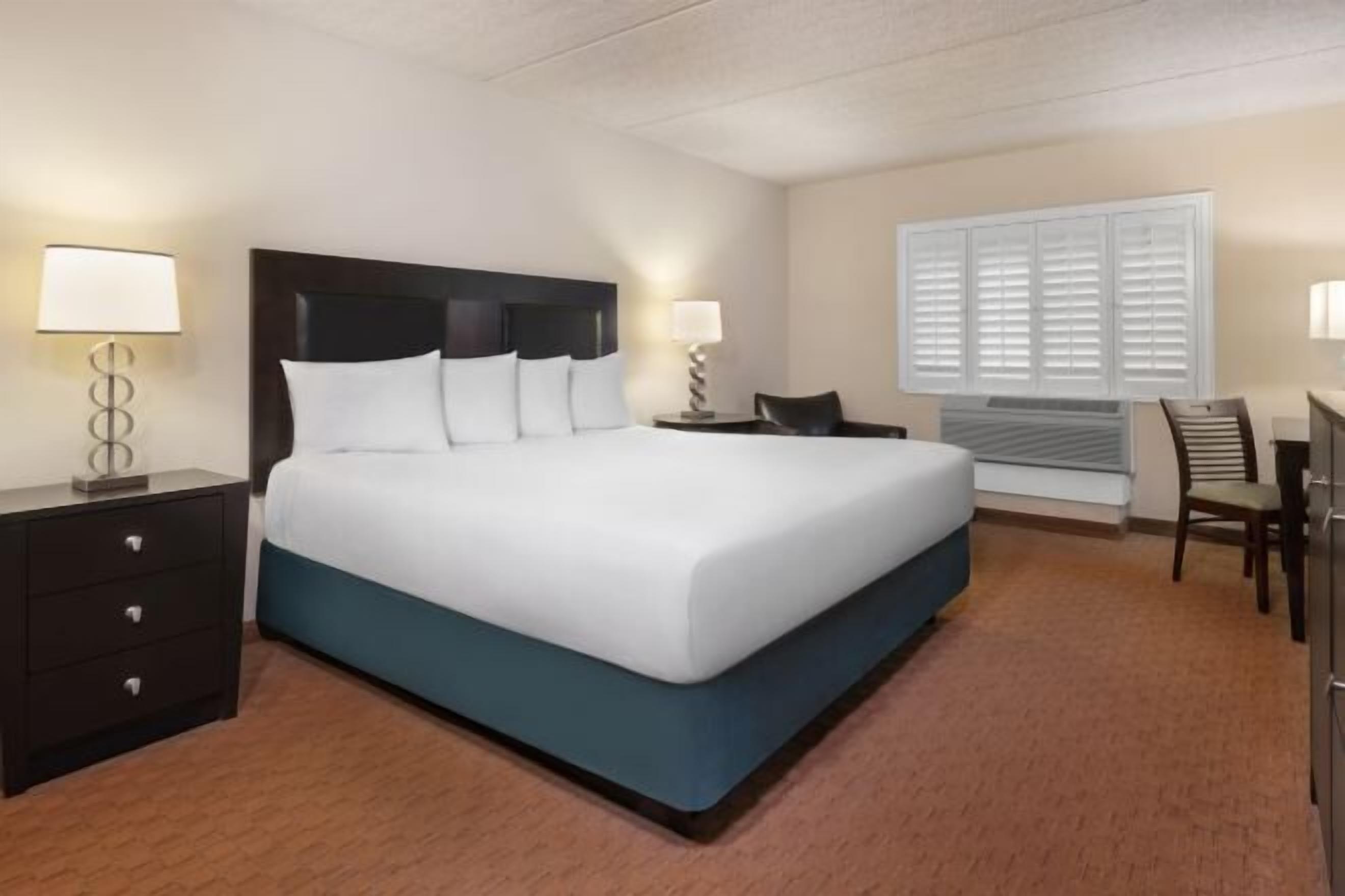 Desk, laptop workspace, iron/ironing board, bed sheets