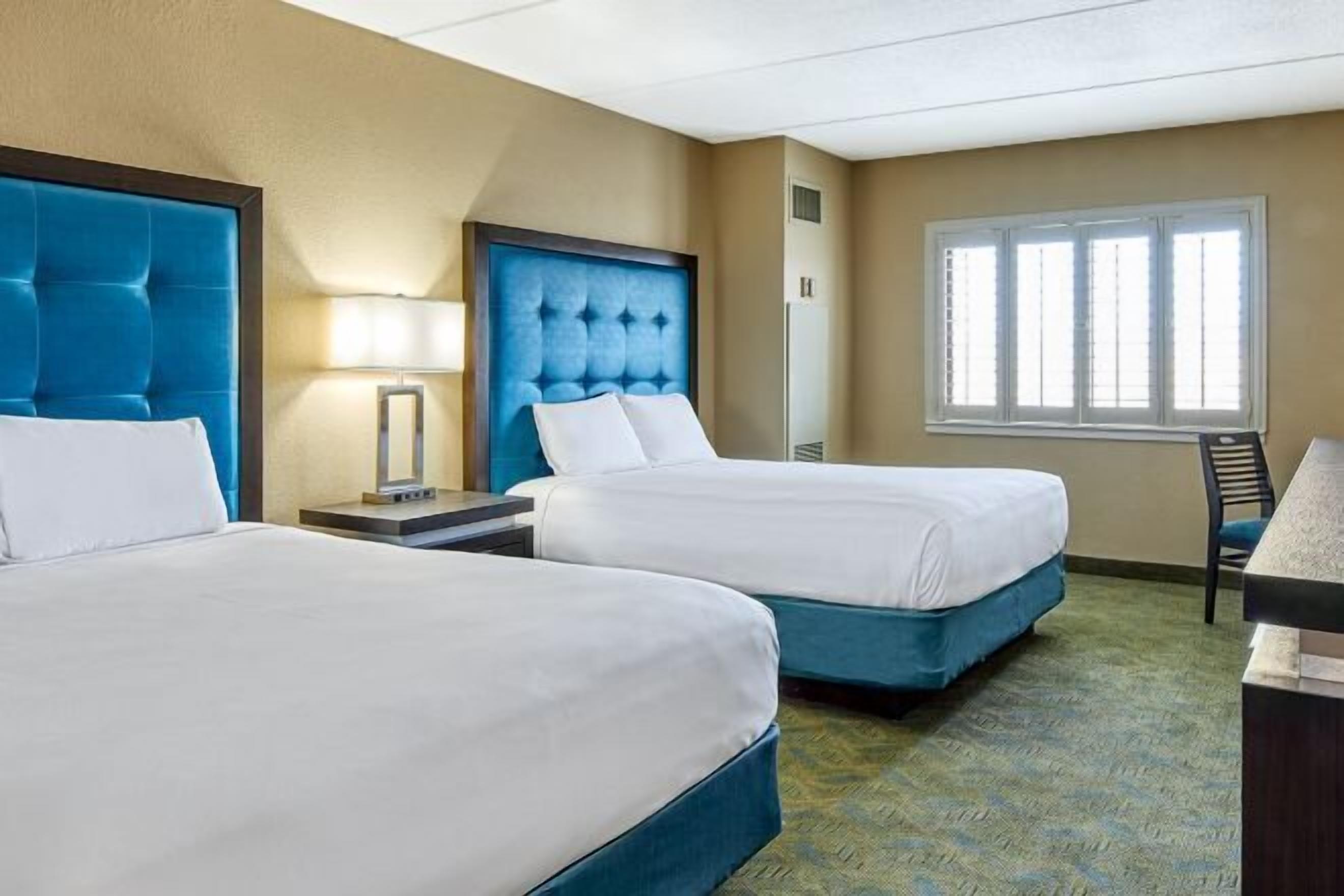 Desk, laptop workspace, iron/ironing board, bed sheets