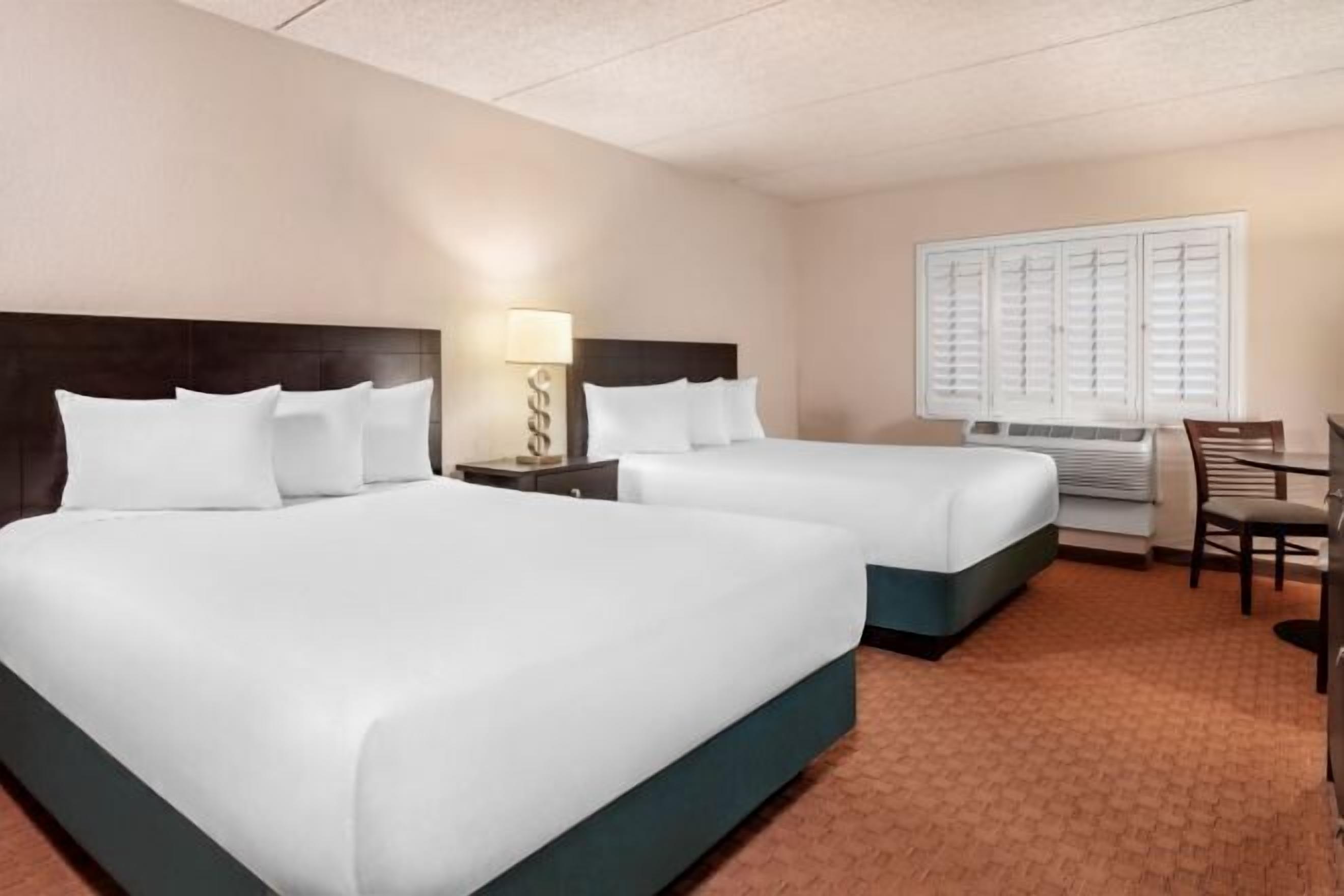 Desk, laptop workspace, iron/ironing board, bed sheets