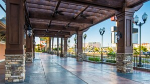 A covered walkway with stone pillars and metal railings, leading to a building with a sign that reads "Tropicana". - Tropicana Laughlin Hotel & Casino - A Caesars Rewards Destination (Laughlin)
