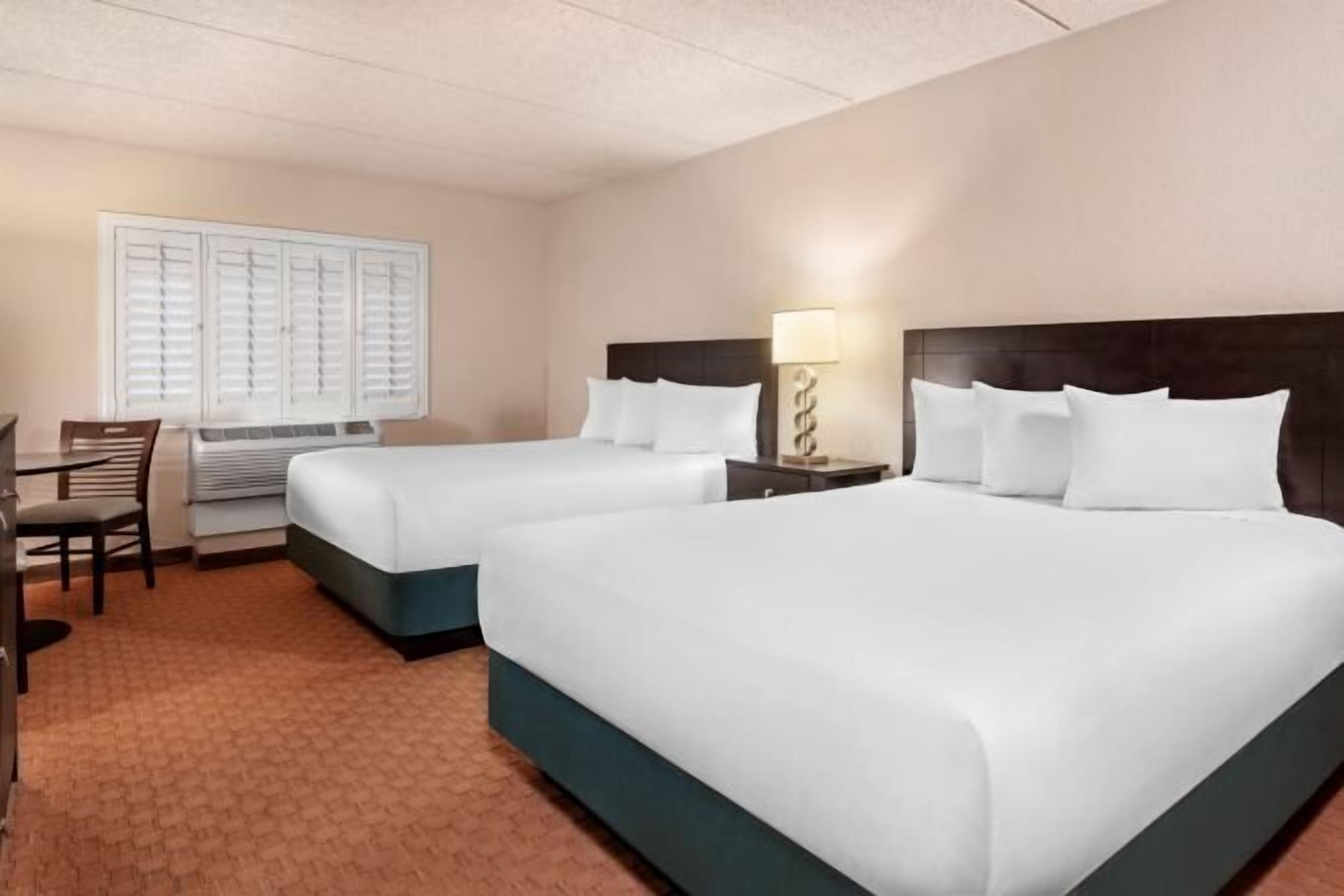 Desk, laptop workspace, iron/ironing board, bed sheets