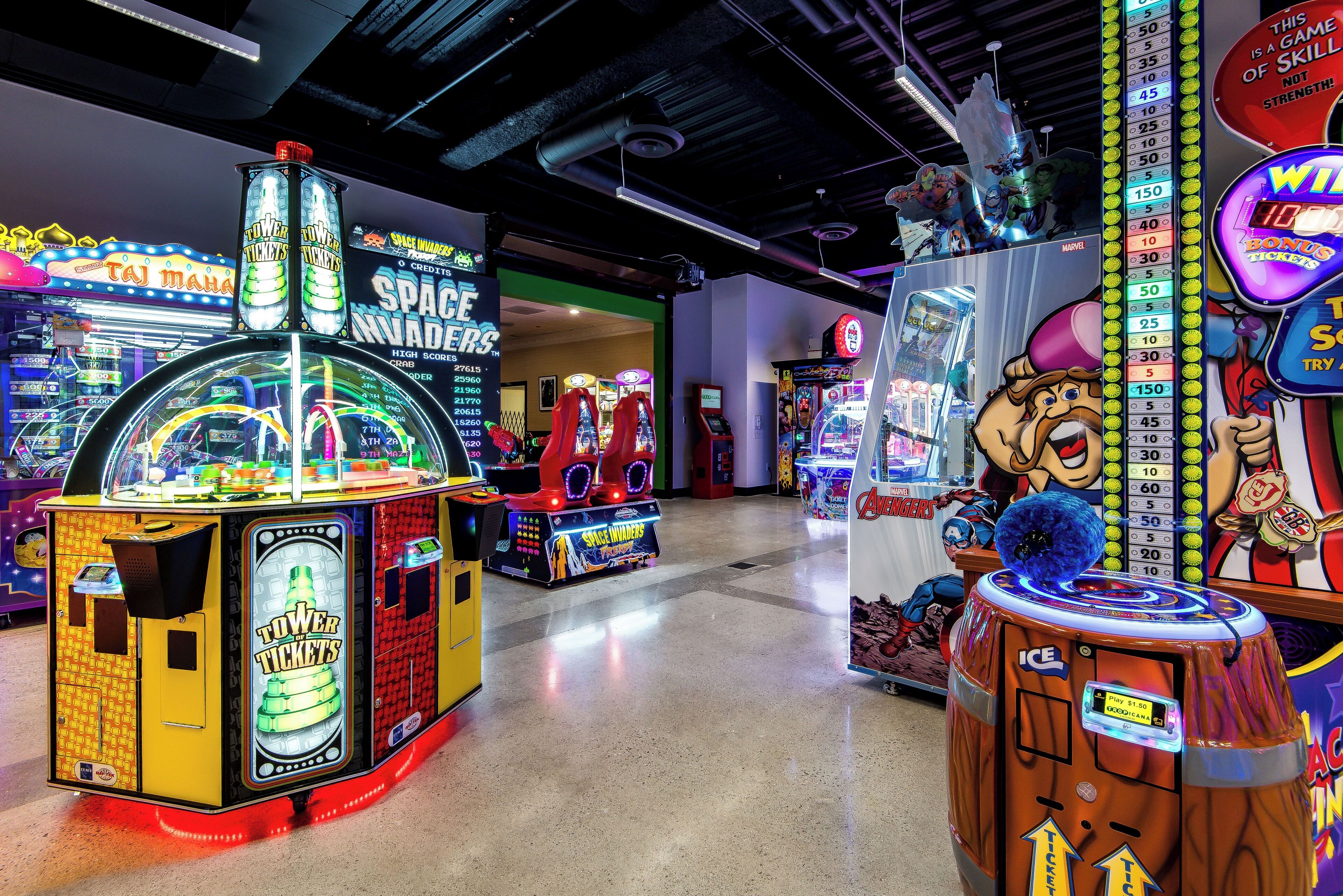 A row of arcade games with various themes, including Space Invaders and Spiders.