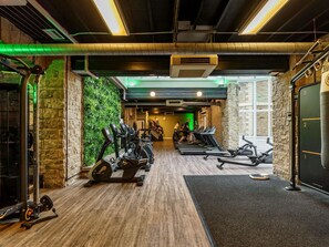 A gym with treadmills, stationary bikes, and weight machines.