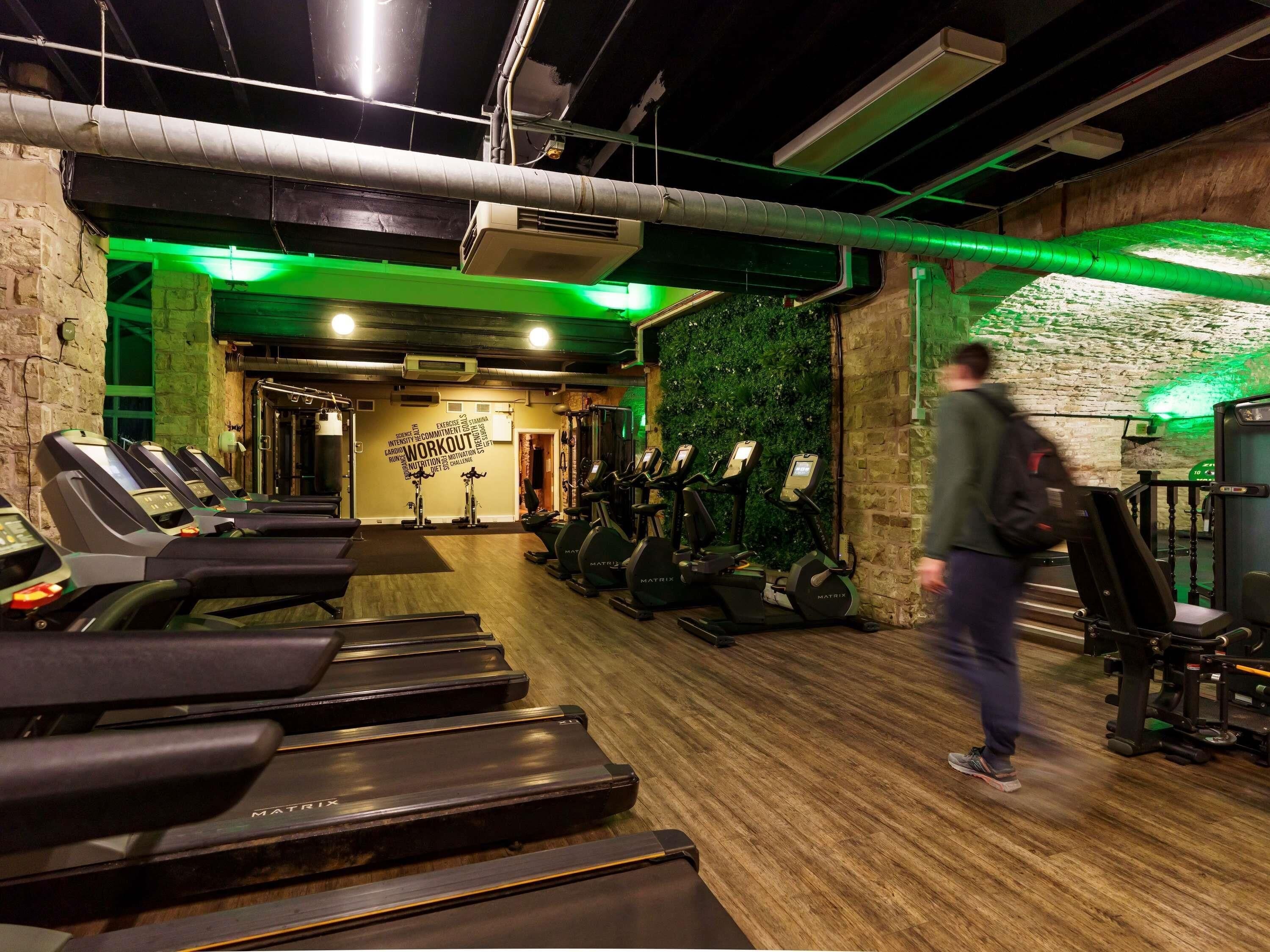 A gym with treadmills, stationary bikes, and weight machines.