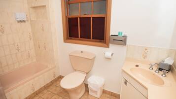 A bathroom with a toilet, sink, and bathtub.