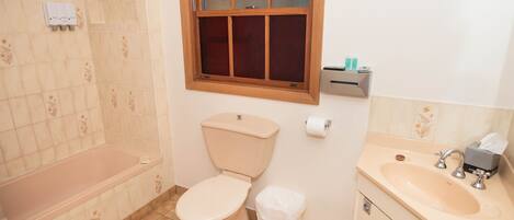 A bathroom with a toilet, sink, and bathtub.