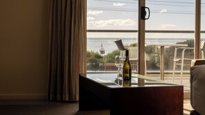 A hotel room with a large window offering a view of the sea and a ship. - Beachfront At Bicheno (Bicheno)