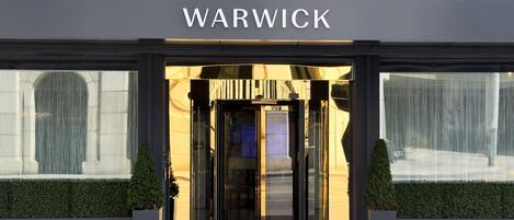 The entrance to a building with a sign that reads 'WARWICK'.