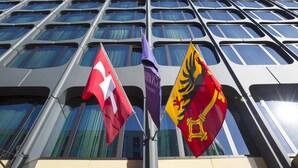 A modern building with a grid of windows and three flags in front. - Warwick Geneva (Geneva)