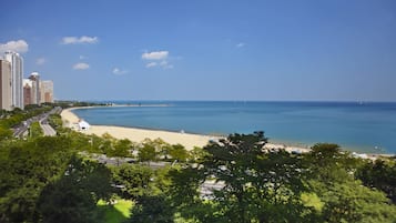 A coastal cityscape with a beach, high-rise buildings, and a clear sky.