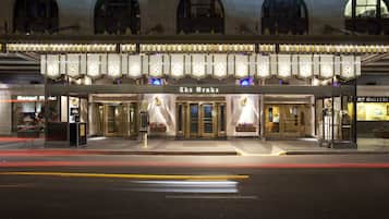 A theater with a marquee reading "The Drake" and a classic facade with arched windows.