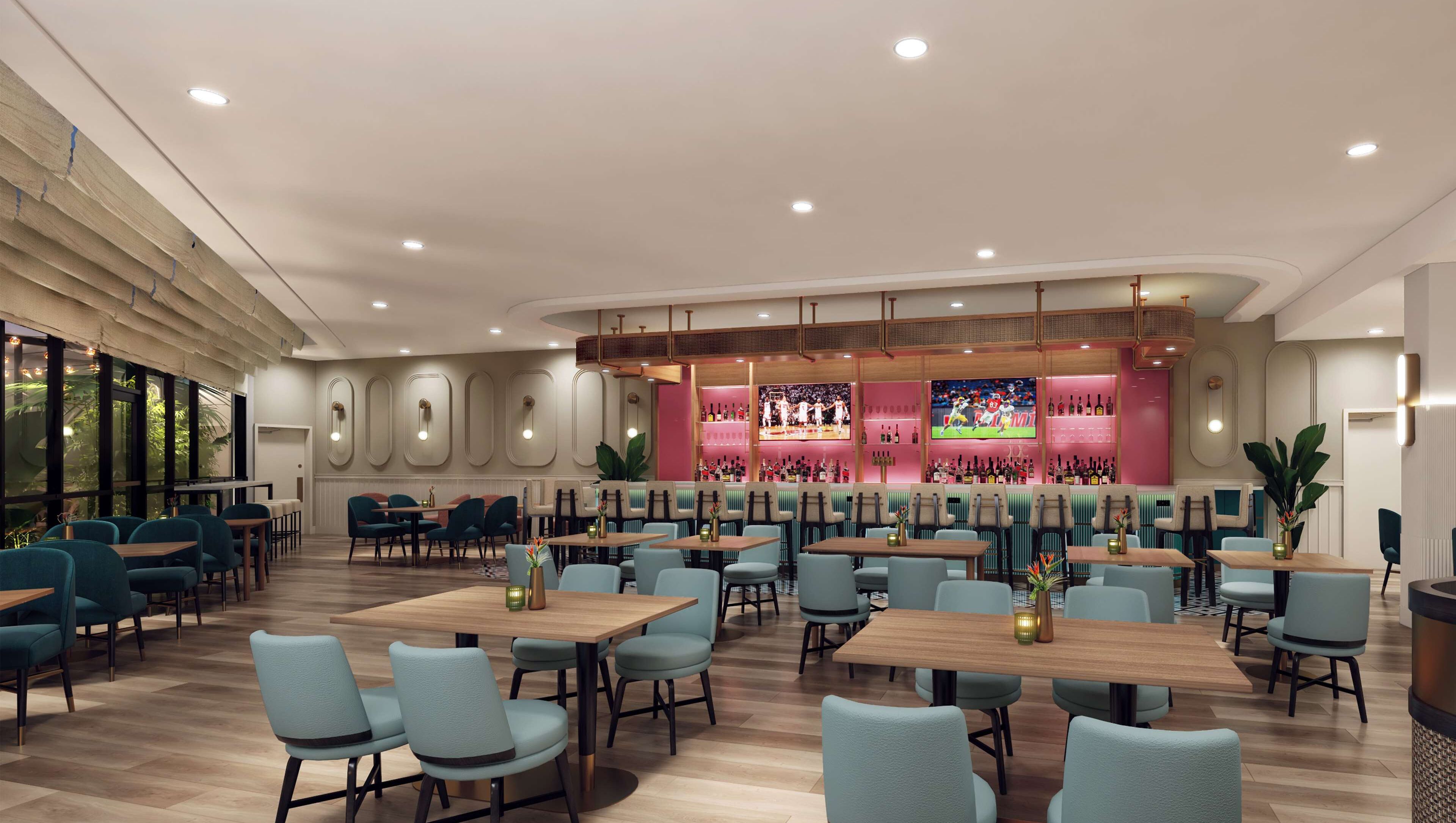 A spacious restaurant with multiple dining areas, a bar with a pink interior, and a large TV screen displaying sports.