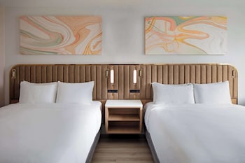 In-room safe, desk, laptop workspace, blackout drapes at Sonesta Miami Airport