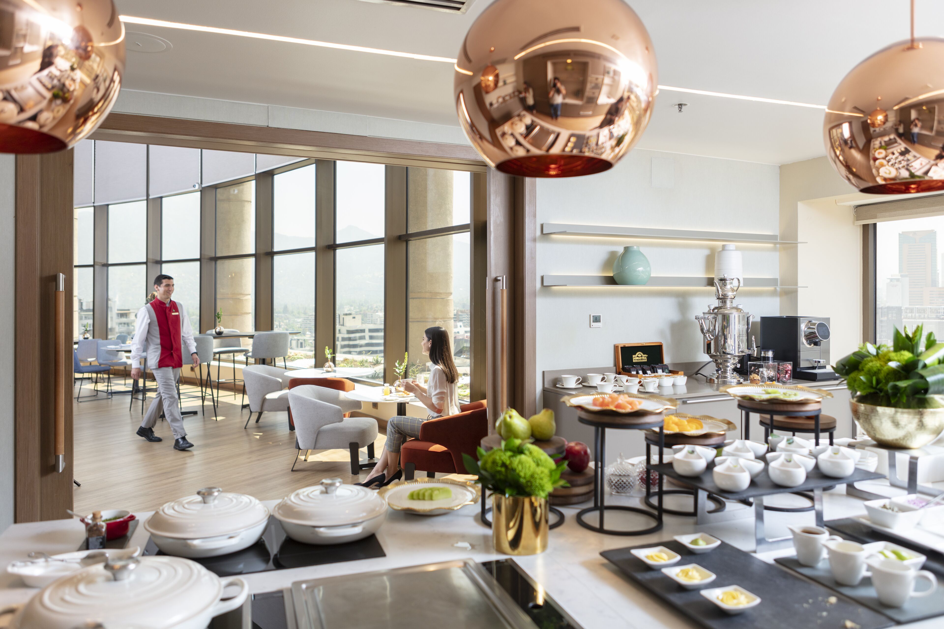 A modern dining area with large windows, a variety of table settings, and a city view.