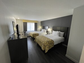 A hotel room with two beds, a desk, a computer, and a window with curtains. - Baymont by Wyndham Branford/New Haven (Branford)