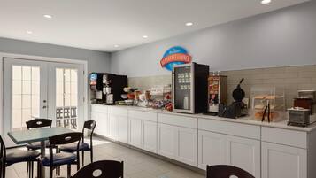 A breakfast area with a counter, seating, and a sign indicating it's the breakfast corner.