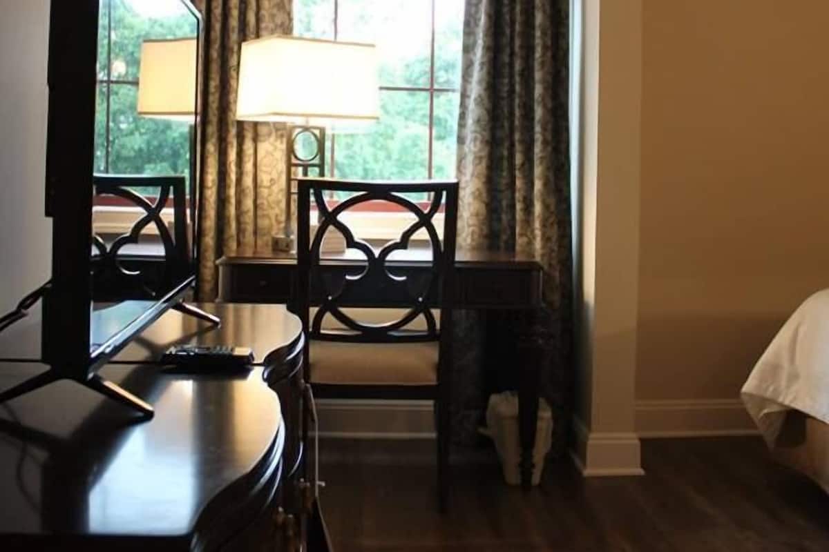 Premium bedding, desk, laptop workspace, blackout drapes