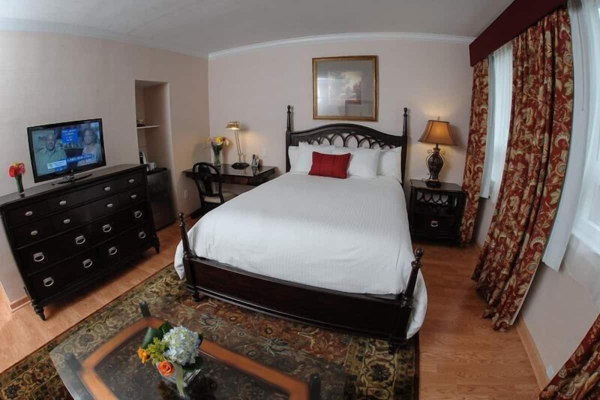 Premium bedding, desk, laptop workspace, blackout drapes