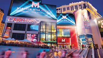 A large building with multiple signs for 'Miracle Mile Shops' and 'Planet Hollywood'.