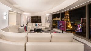A modern living room with a large window offering a city view, a sofa set, and a coffee table. - Planet Hollywood Resort & Casino (Las Vegas)