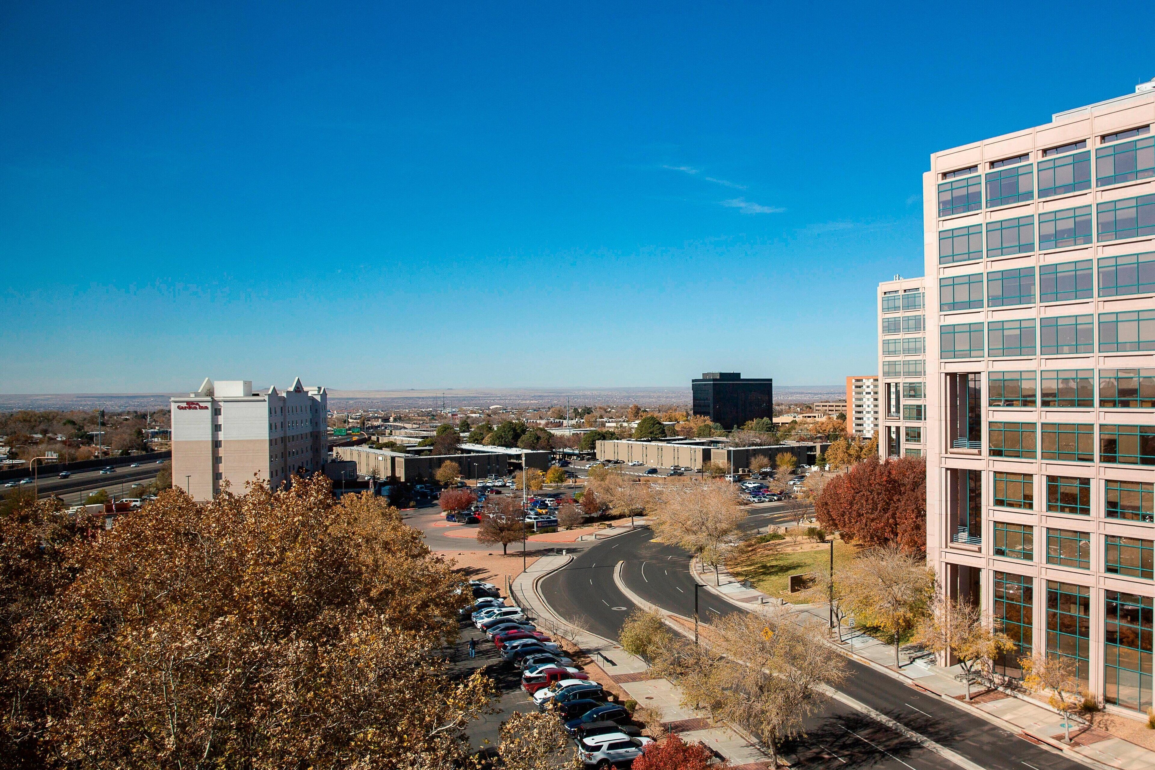 A modern building with a parking lot and a road.