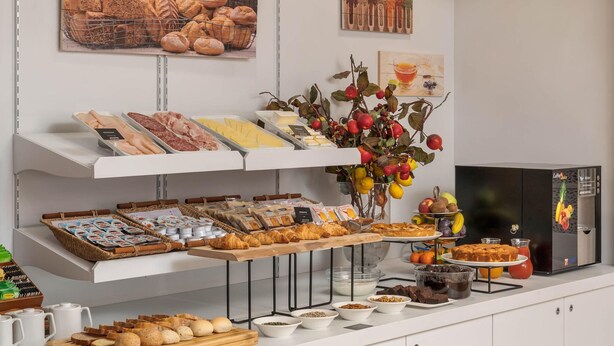 A breakfast buffet with various food items, including bread, pastries, and fruits. - B&B Hotel Treviso Al Fogher (Treviso)