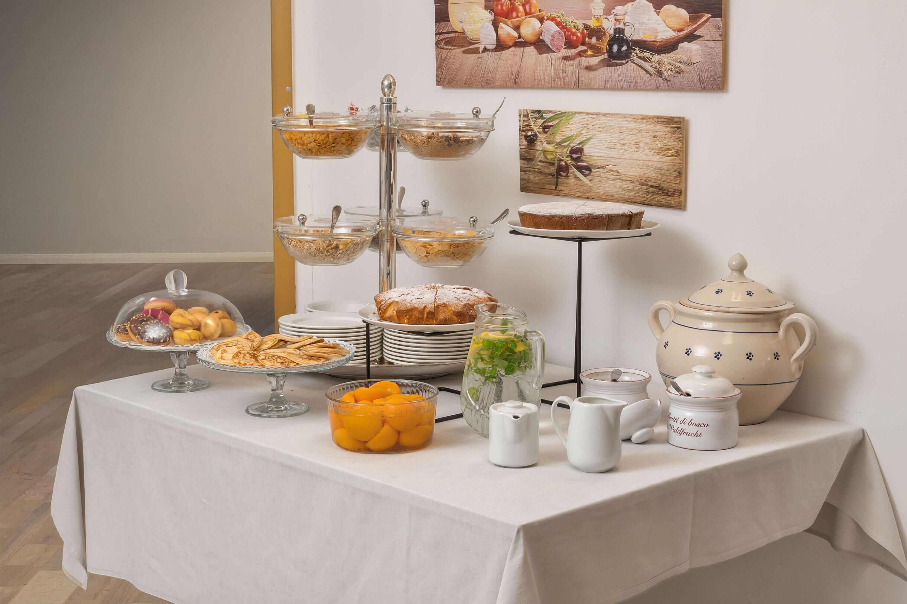 A buffet table with various food items and serving dishes.