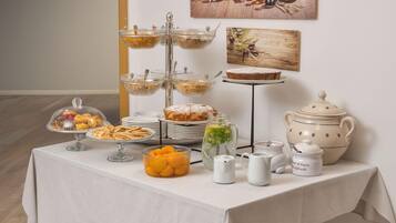 A buffet table with various food items and serving dishes.