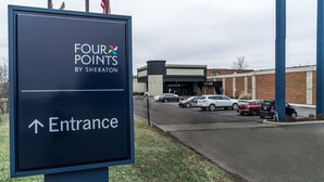 A sign for 'Four Points by Sheraton' with an arrow pointing to the entrance. - Four Points by Sheraton Detroit Novi (Novi)