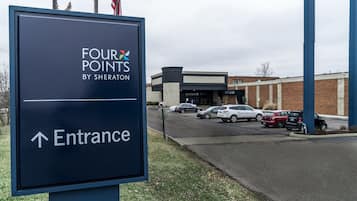 A sign for 'Four Points by Sheraton' with an arrow pointing to the entrance.
