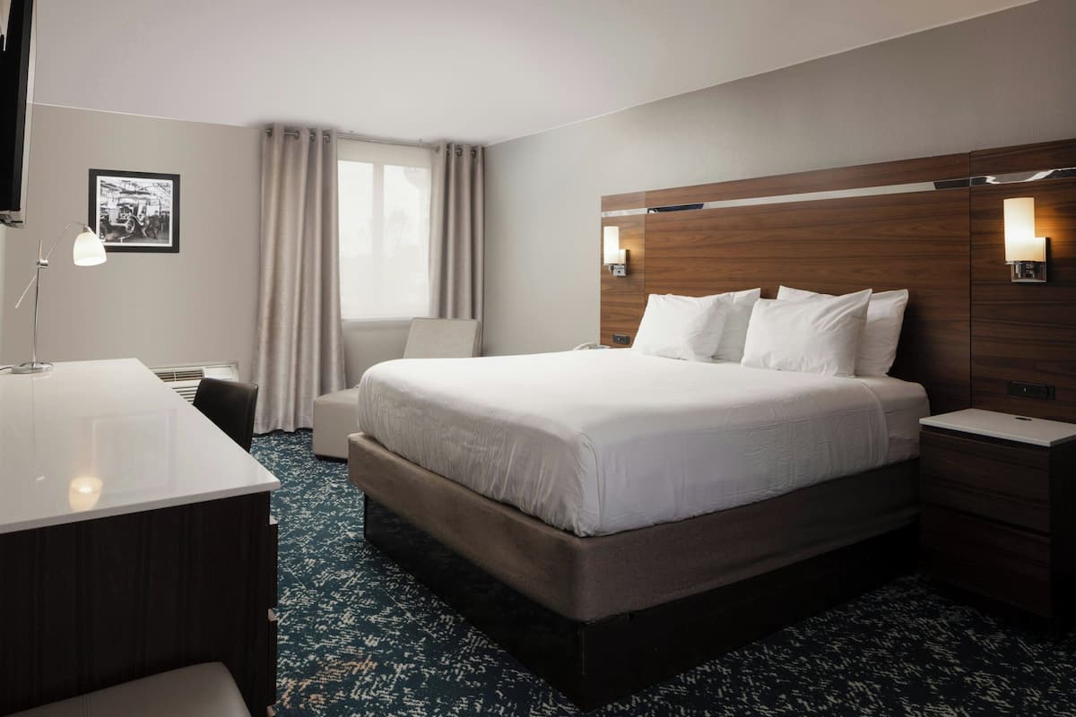Premium bedding, desk, laptop workspace, iron/ironing board