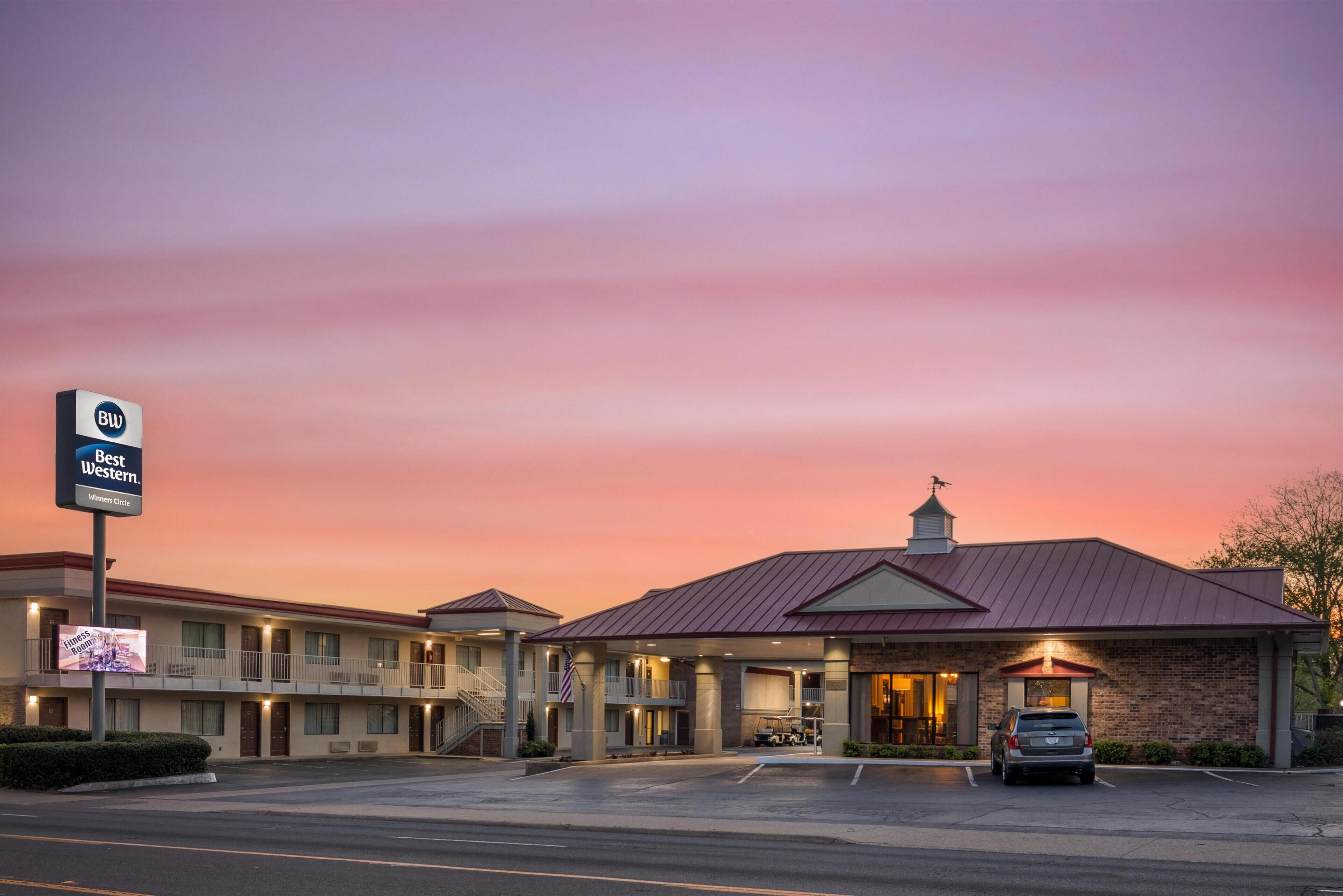 A Best Western hotel with a brick facade, multiple balconies, and a parking lot.